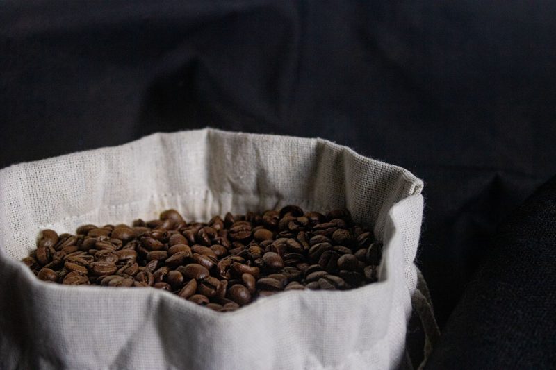 Roasted coffee beans in a cloth sack