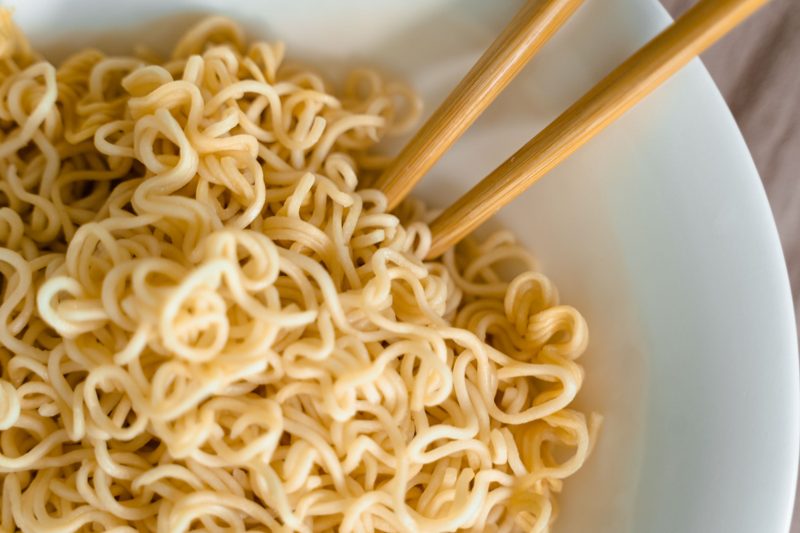 Cooked instant noodles lifted with chopsticks